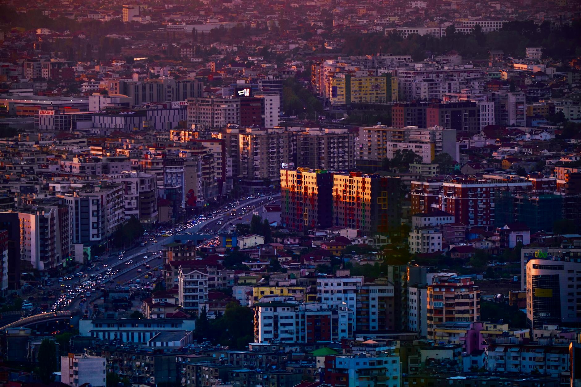 Aerial view of Tirana, Albania's vibrant cityscape, captured during golden hour, highlighting urban architecture.