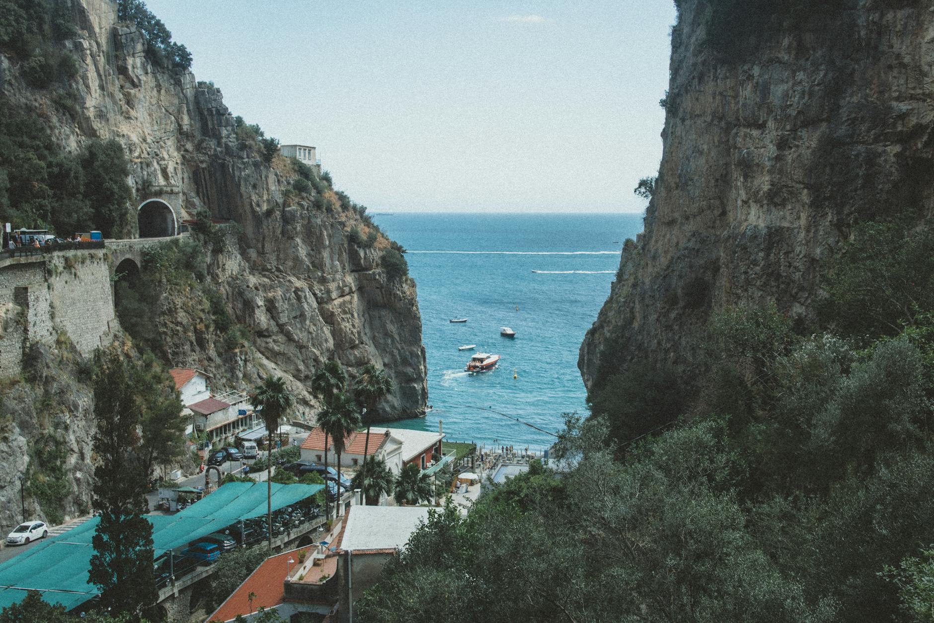 Explore the breathtaking cliffs and azure waters of Furore Beach Bay in Campania, Italy.