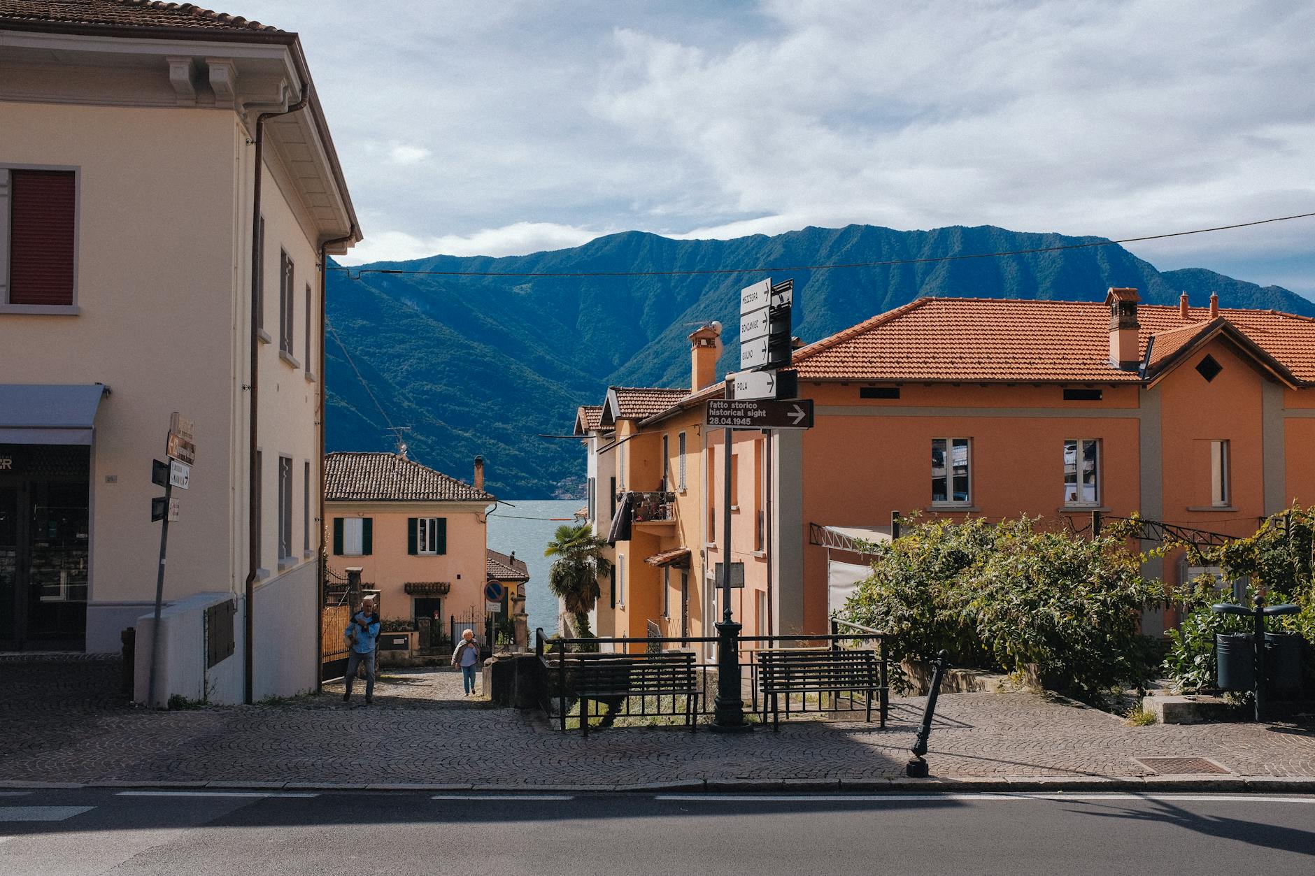 Picturesque street view of a charming village with mountains in the background.