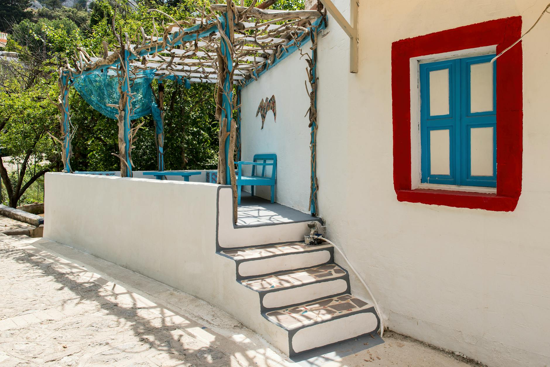 Explore the picturesque Greek architecture and vibrant colors of a traditional home in Kos, Greece.