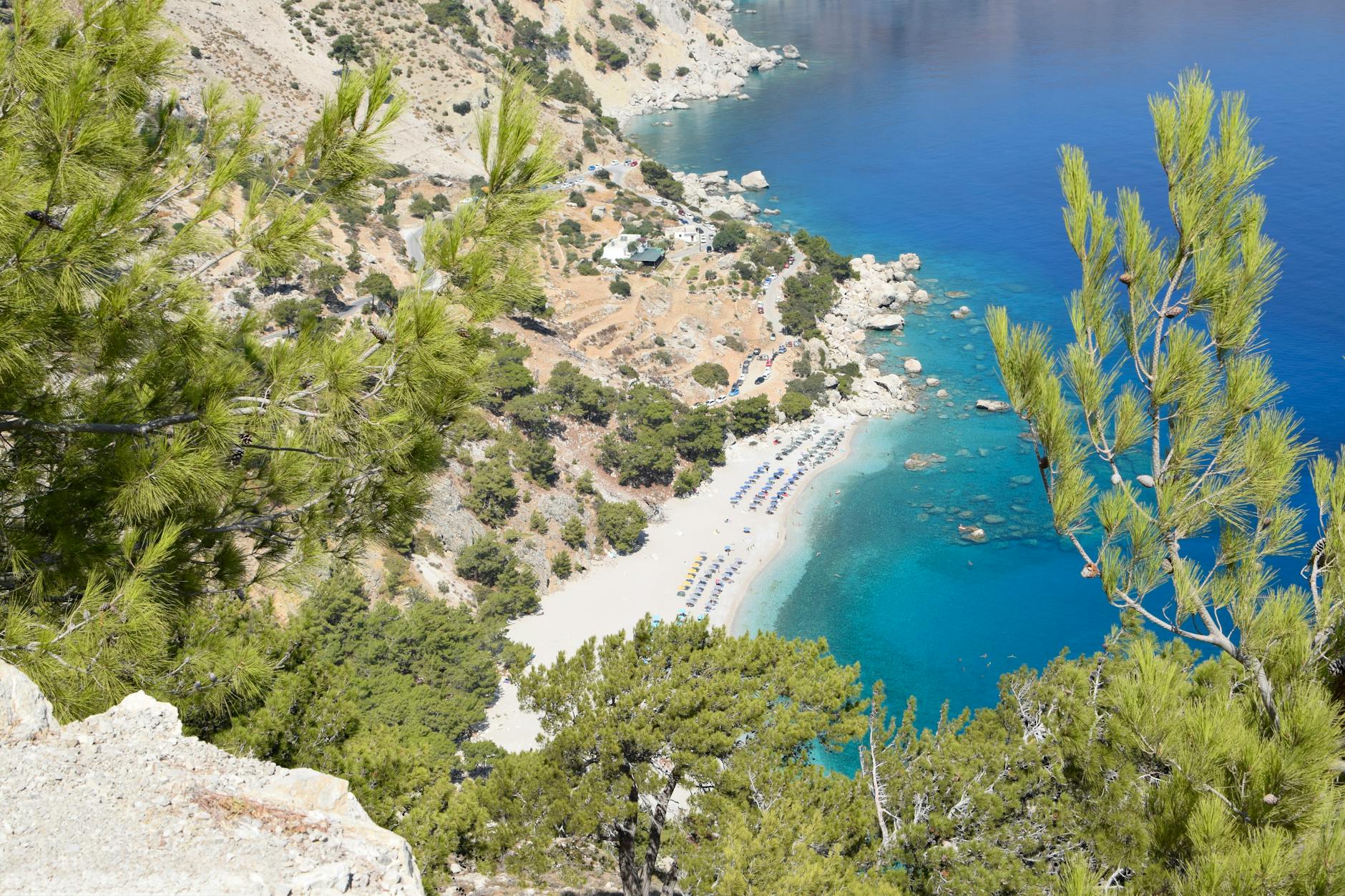 Stunning aerial view of Kyra Panagia Beach on Karpathos, Greece with turquoise waters and lush greenery.