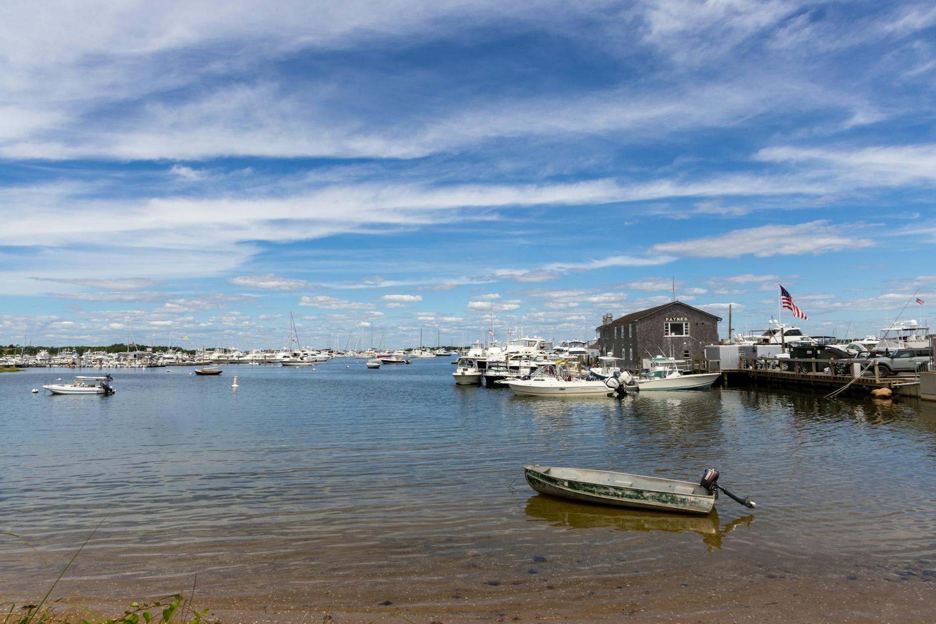 Beautiful view of Newport Harbor with boats docked under a clear blue sky.