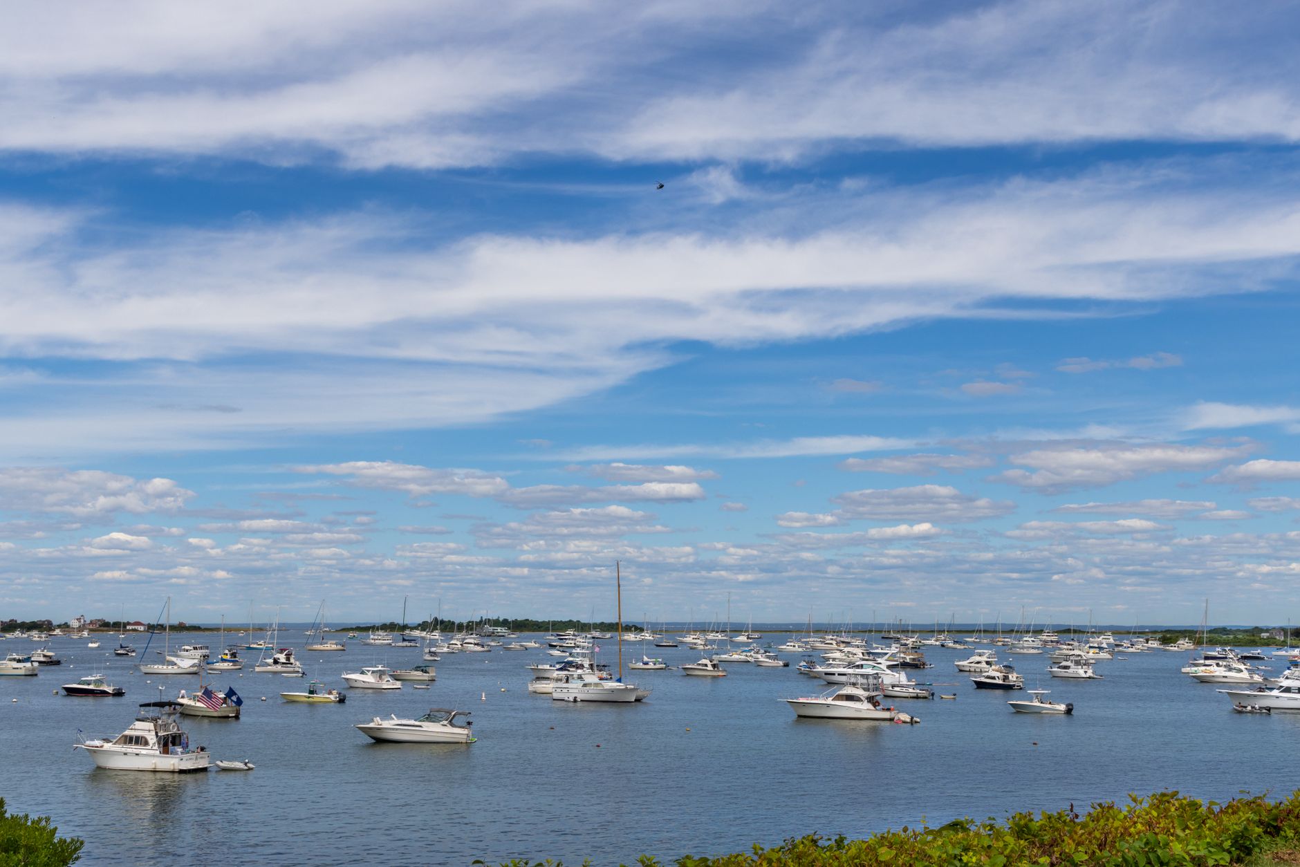 Tranquil view of boats anchored under a blue sky in Newport, Rhode Island.