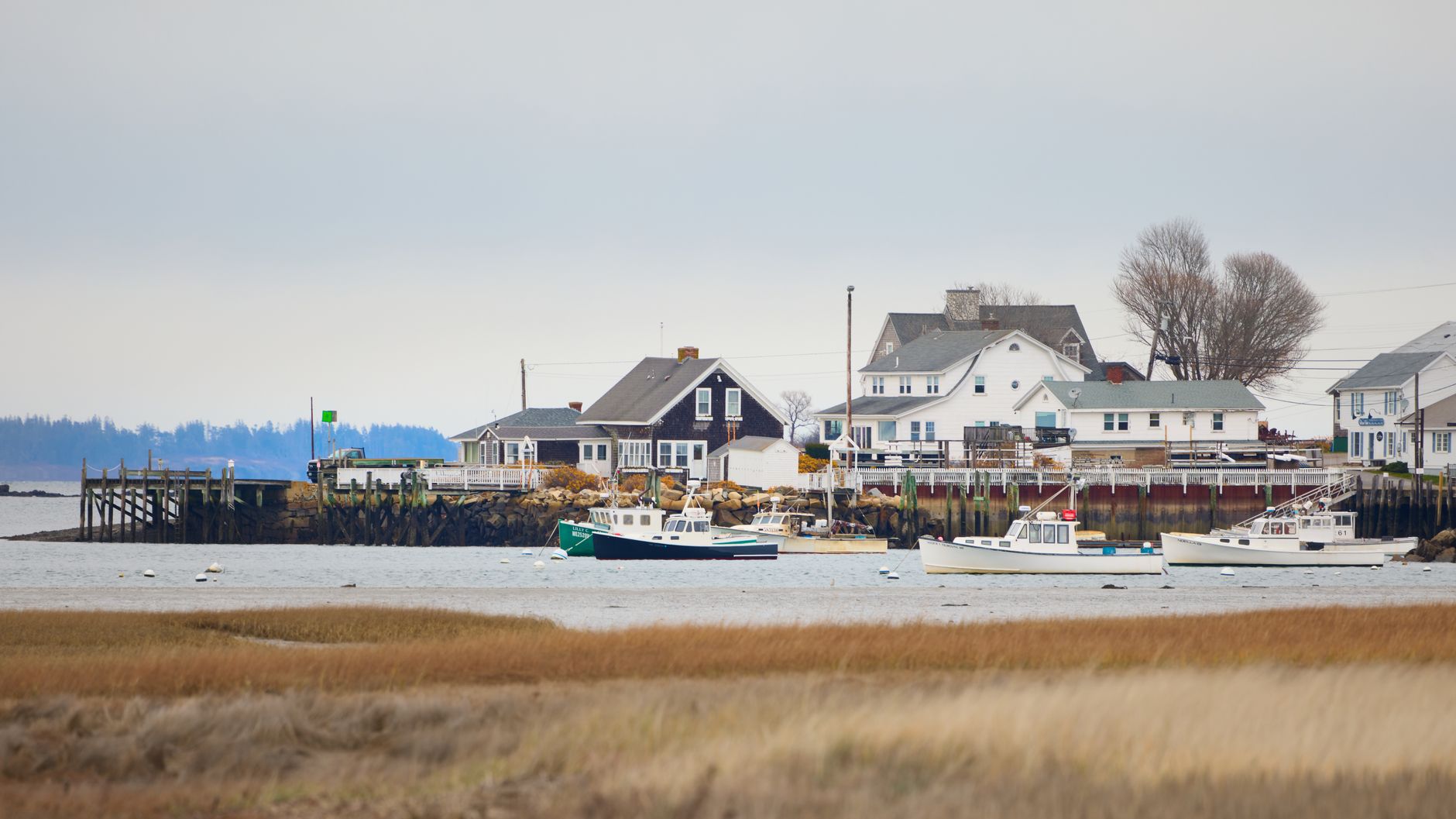 Quaint coastal town view with boats and homes in Biddeford, Maine, USA.