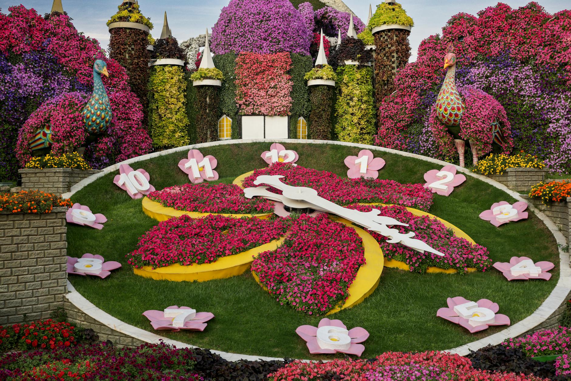 A colorful flower clock with vibrant blooms in a picturesque garden landscape.