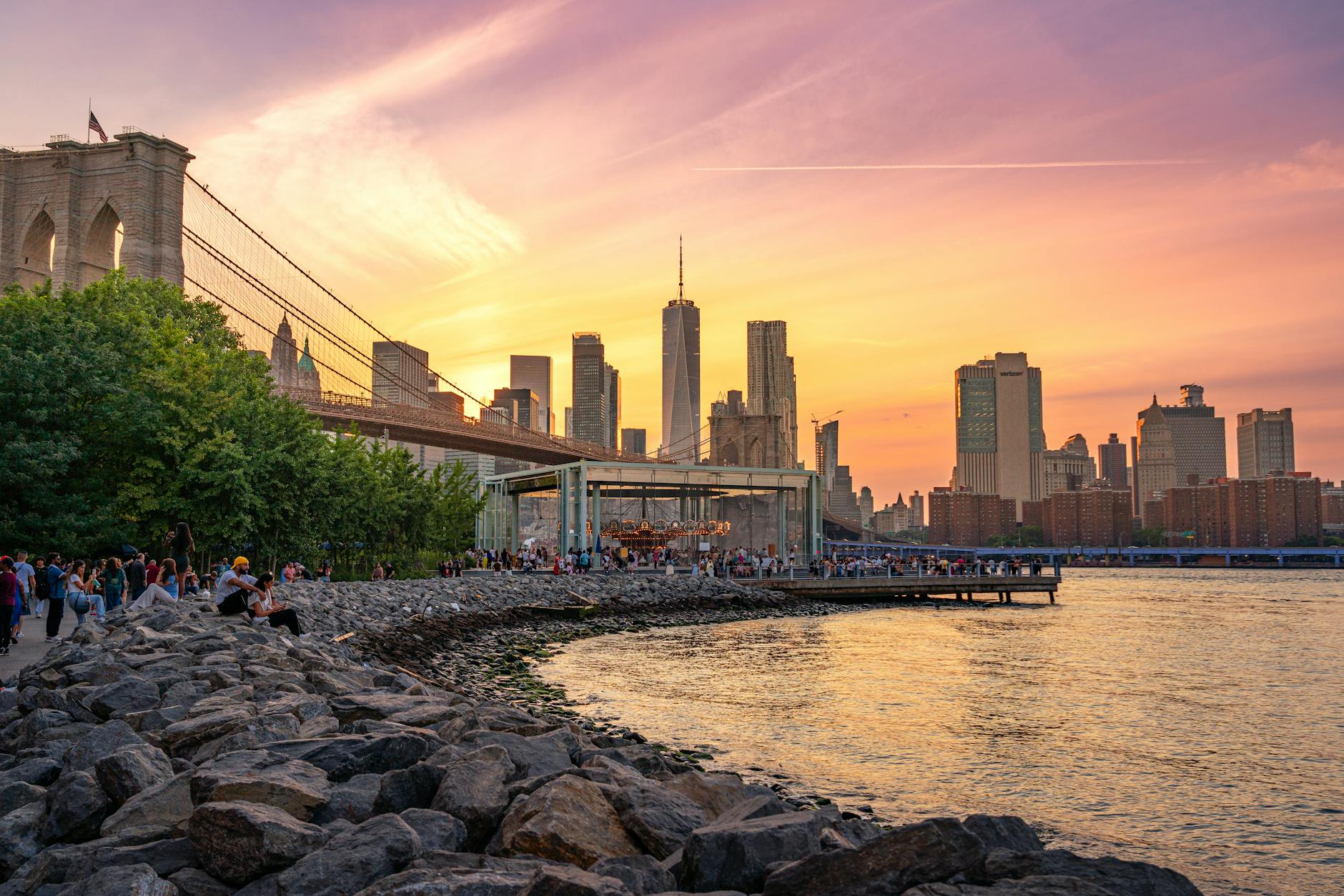 Beautiful sunset view of the Brooklyn Bridge and Manhattan skyline from New York City waterfront.
