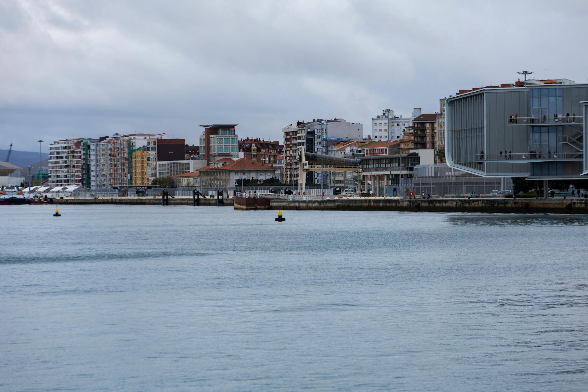 Panoramic view of Santander's waterfront buildings under cloudy skies.